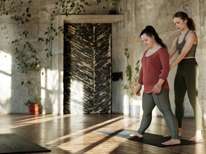 Person practicing yoga in a modern dark interior.